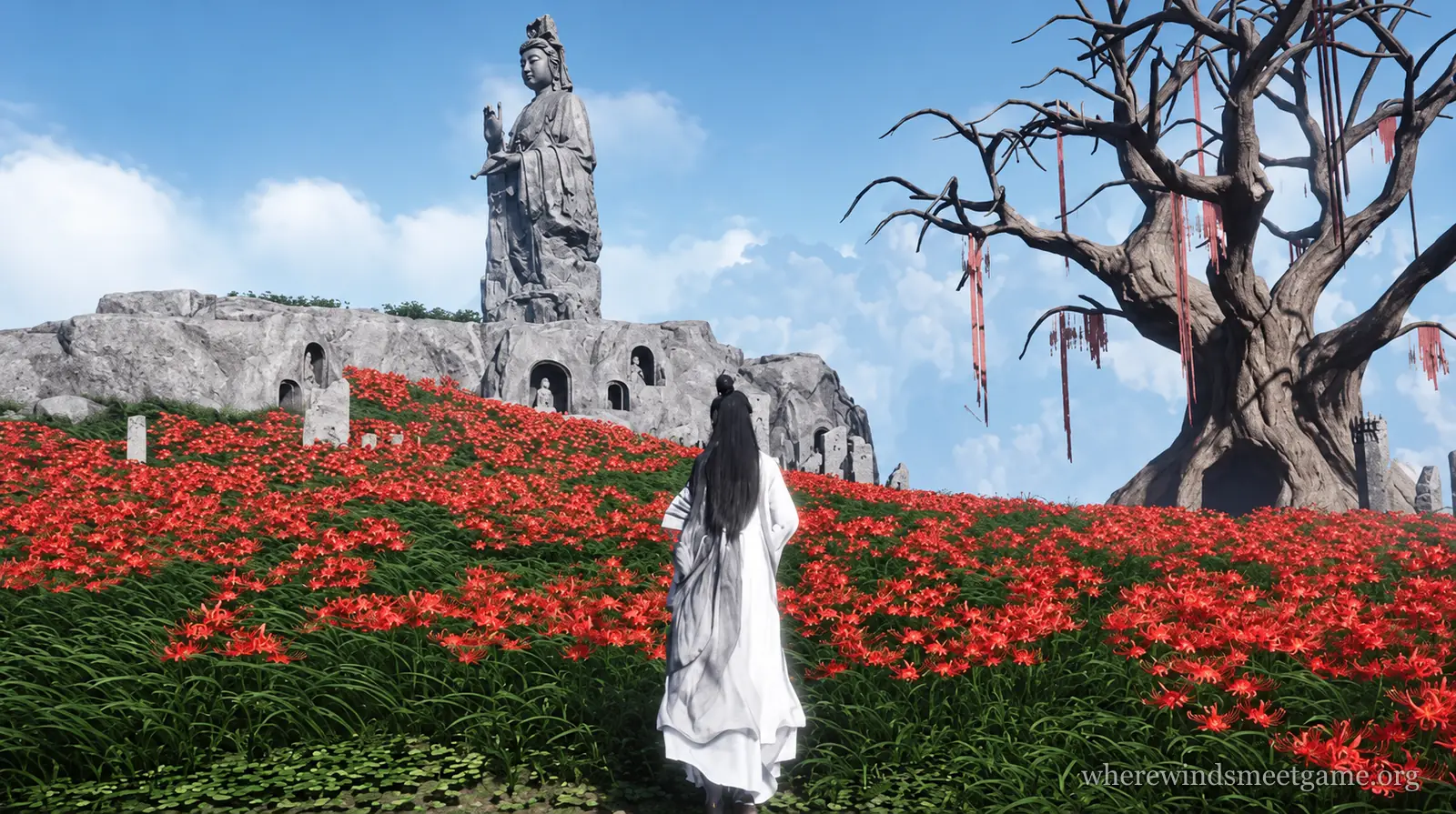 Where Winds Meet game image: a figure in a long white robe stands in a field of red spider lilies below a tall stone statue on a rocky cliff, with a dead tree hung with red ribbons on the right